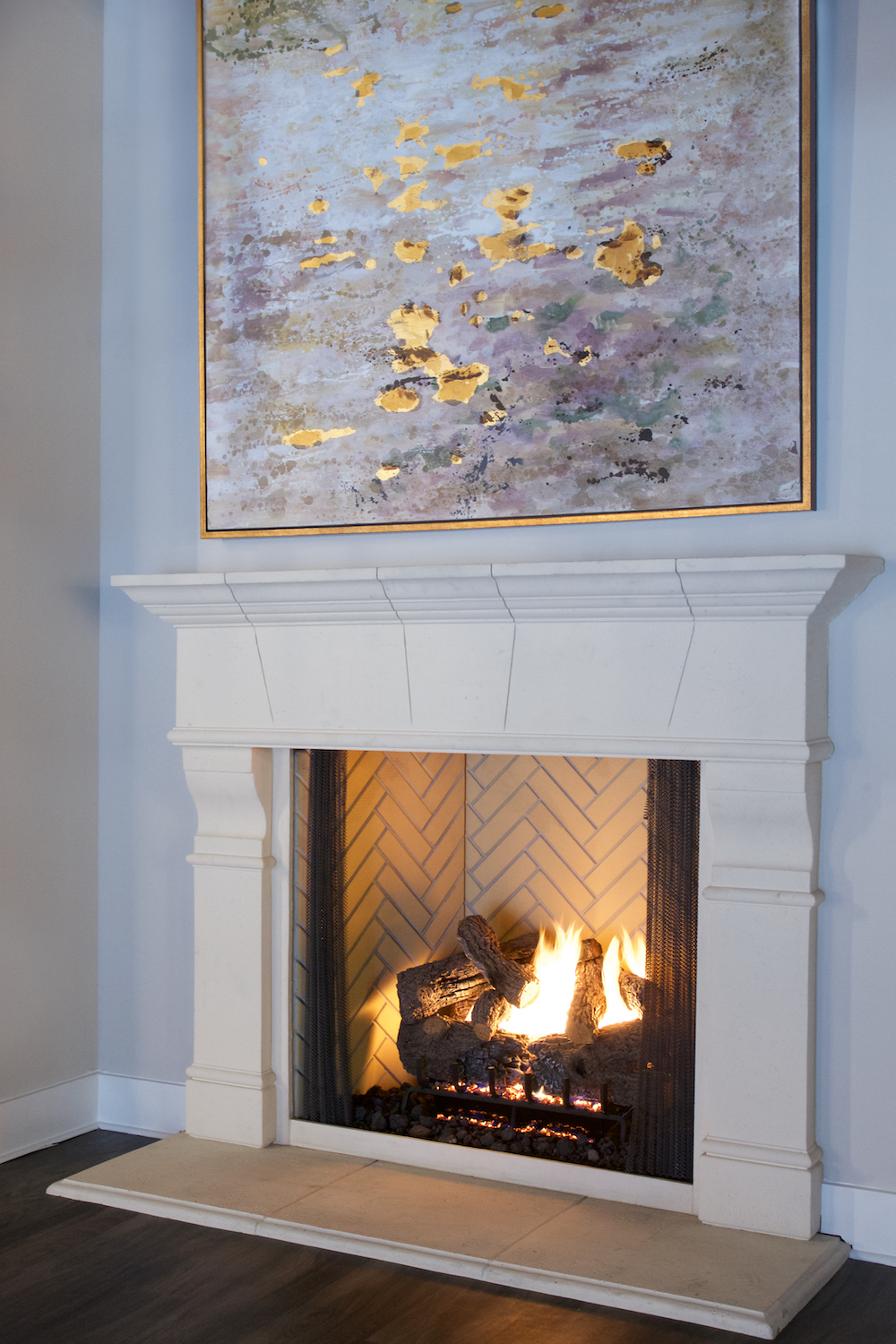 modern wall art with gold Frame, fireplace with white mantel by Construction Resources in Georgia