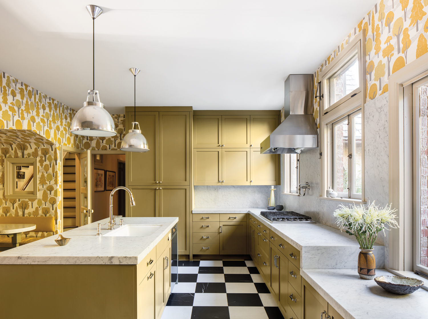 Kitchen with yellow cabinetry, white marble countertops and black-and-white checkered floors