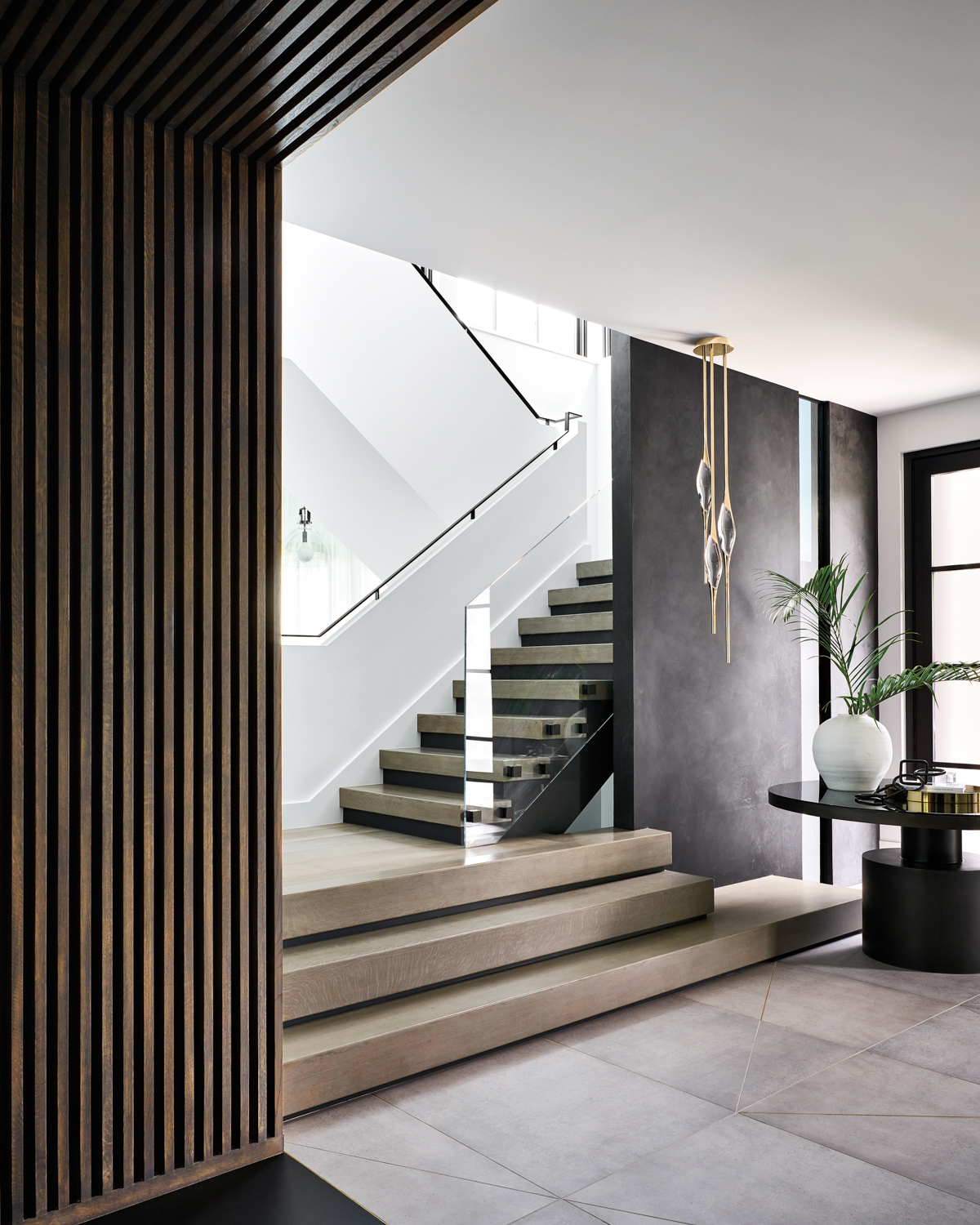 modern glass-rail staircase with a...