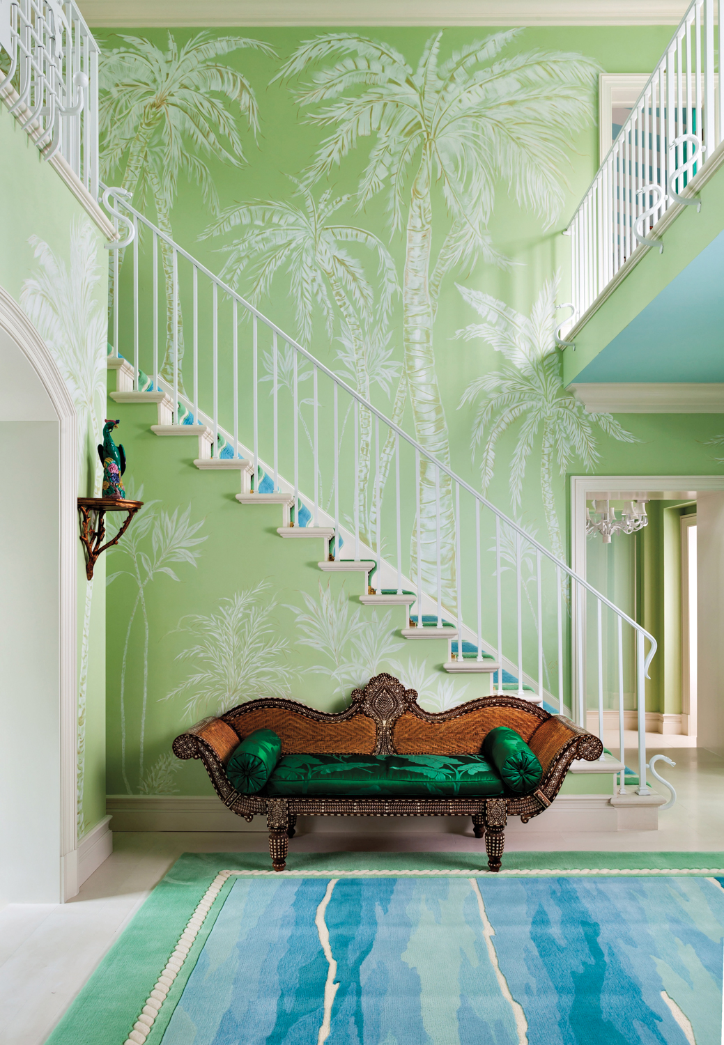 minty green and ocean blue room with palm tree motif mural