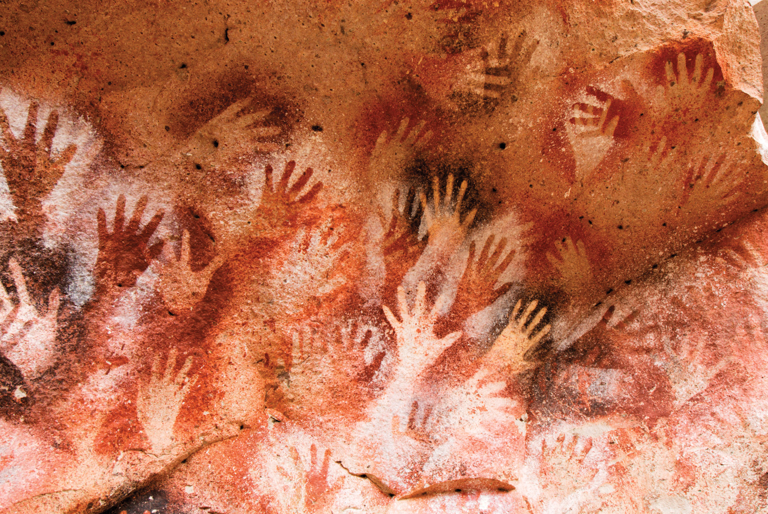 a red-hued artwork of stenciled hands helps explain why red is a power color 