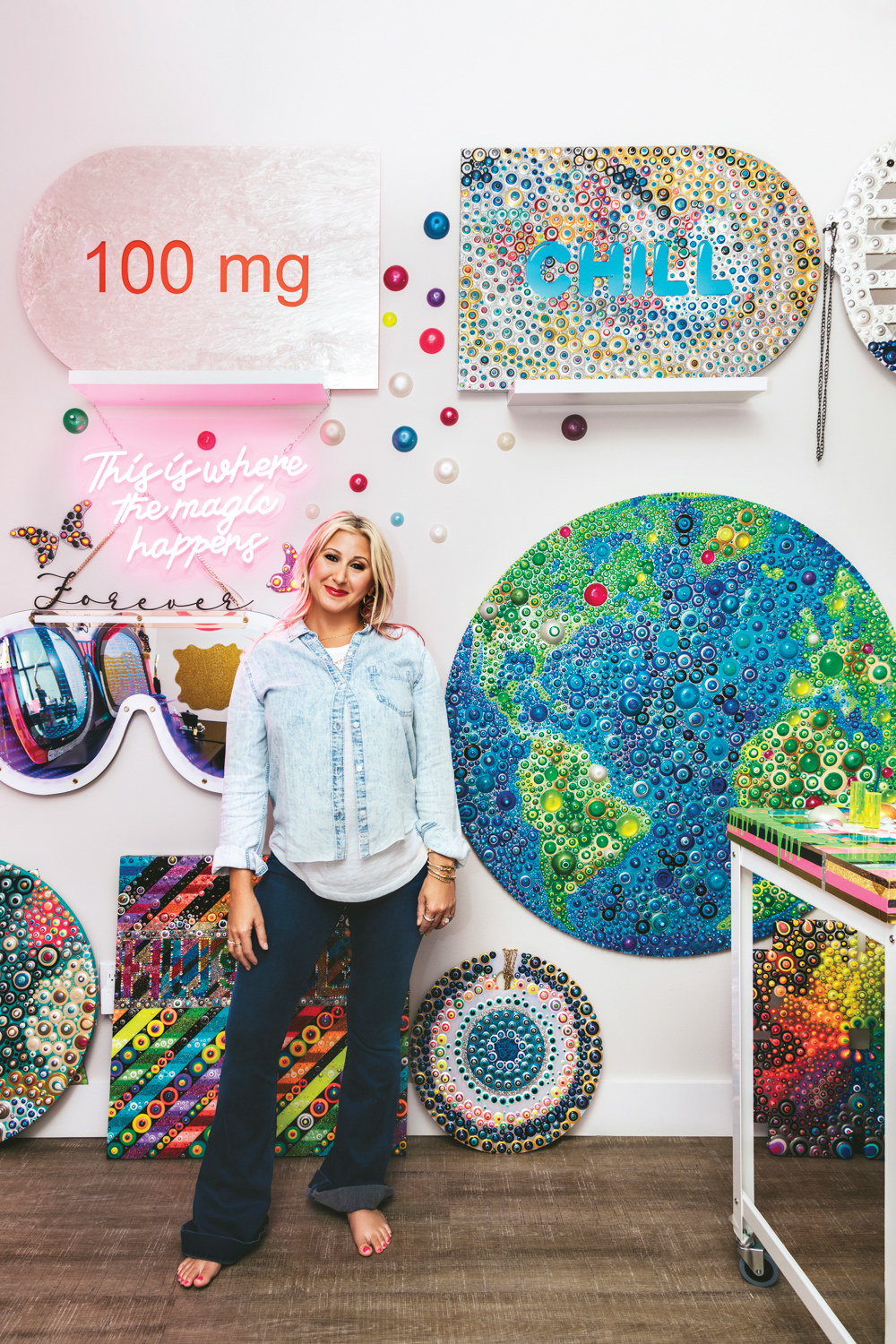 artist jillian whelan in her studio with artworks behind her