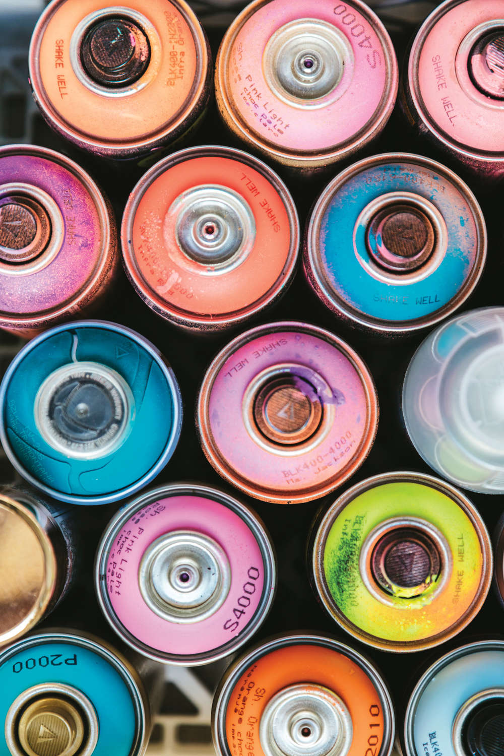 cans of colorful spray paint in jillian whelan's studio