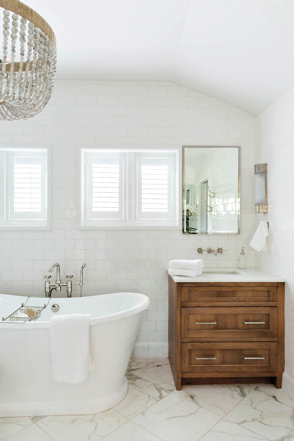 primary bathroom with beaded chandelier,...