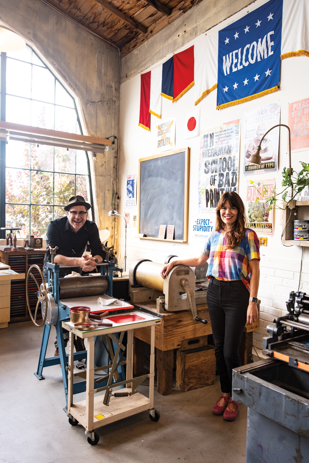 Matt Reynoso and Lena Verderano Reynoso pose in the print shop of Compound Gallery.