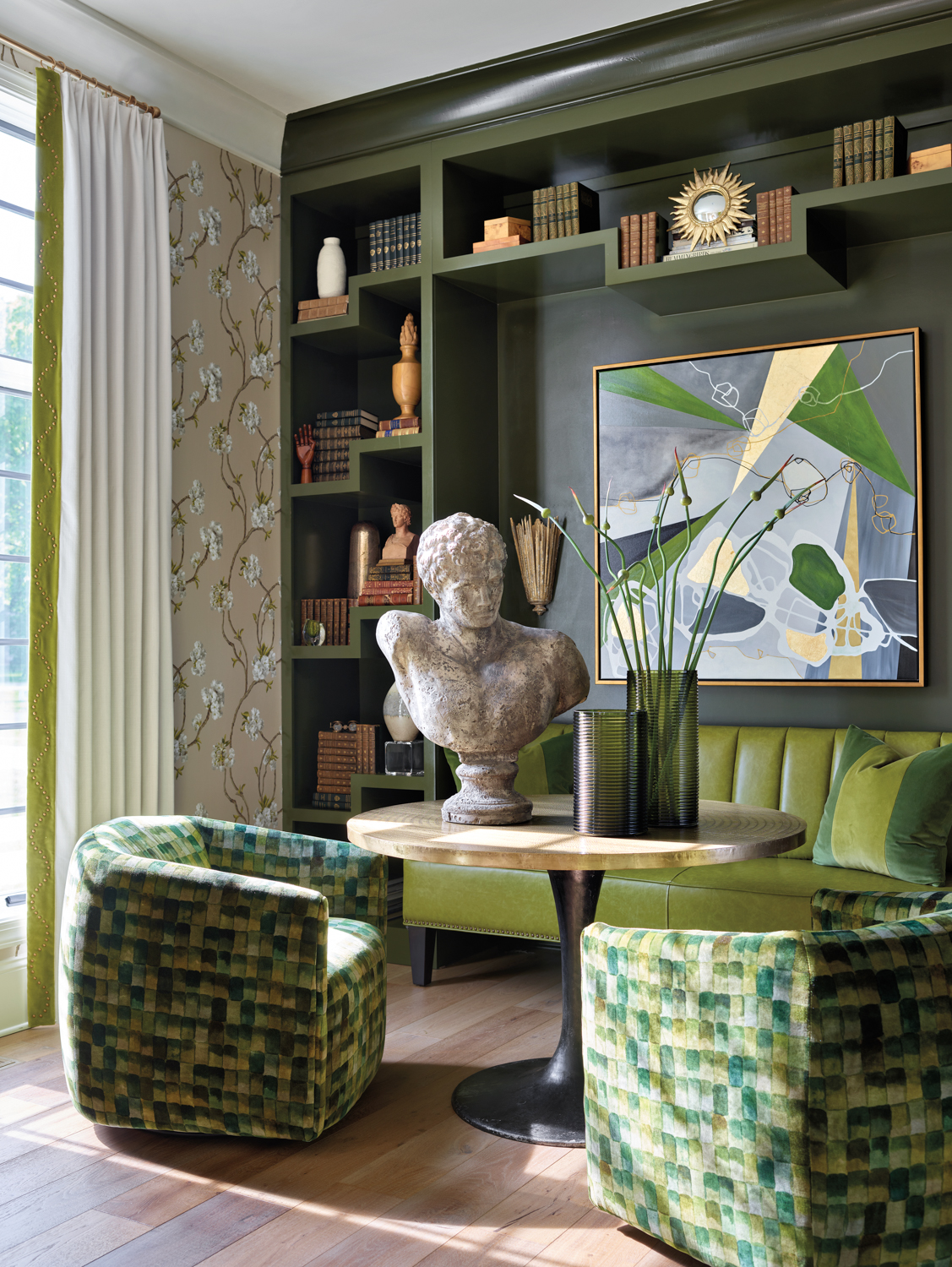 Lounge area with green-painted built-ins,...