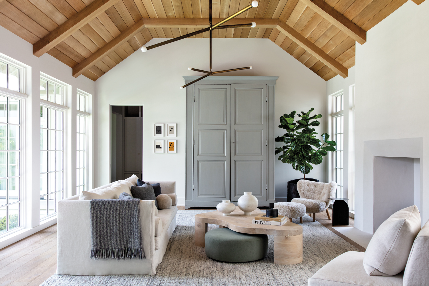 living room with a wood ceiling and monochromatic furnishings