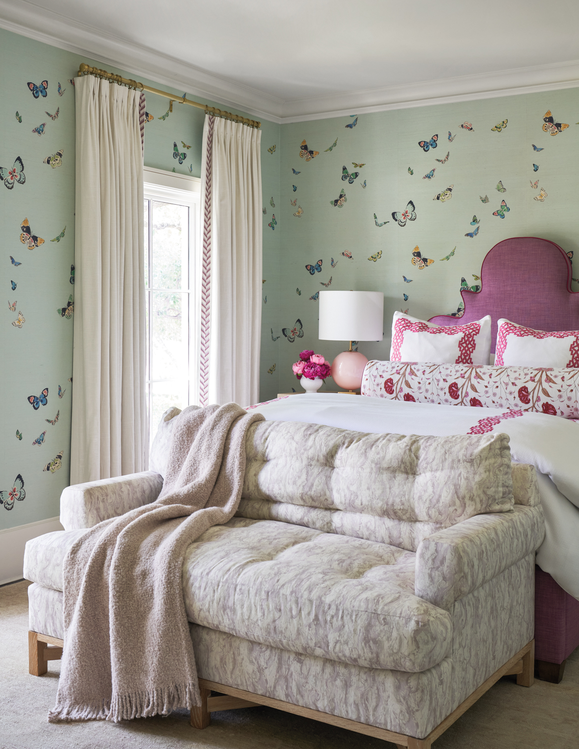 bedroom with butterfly wallpaper and...