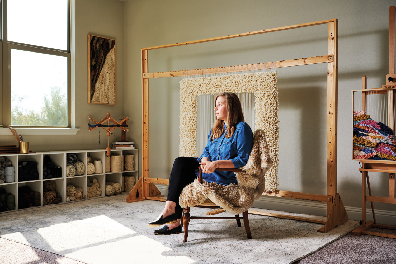 textile artist Shaylee Southerland sitting in front of a loom
