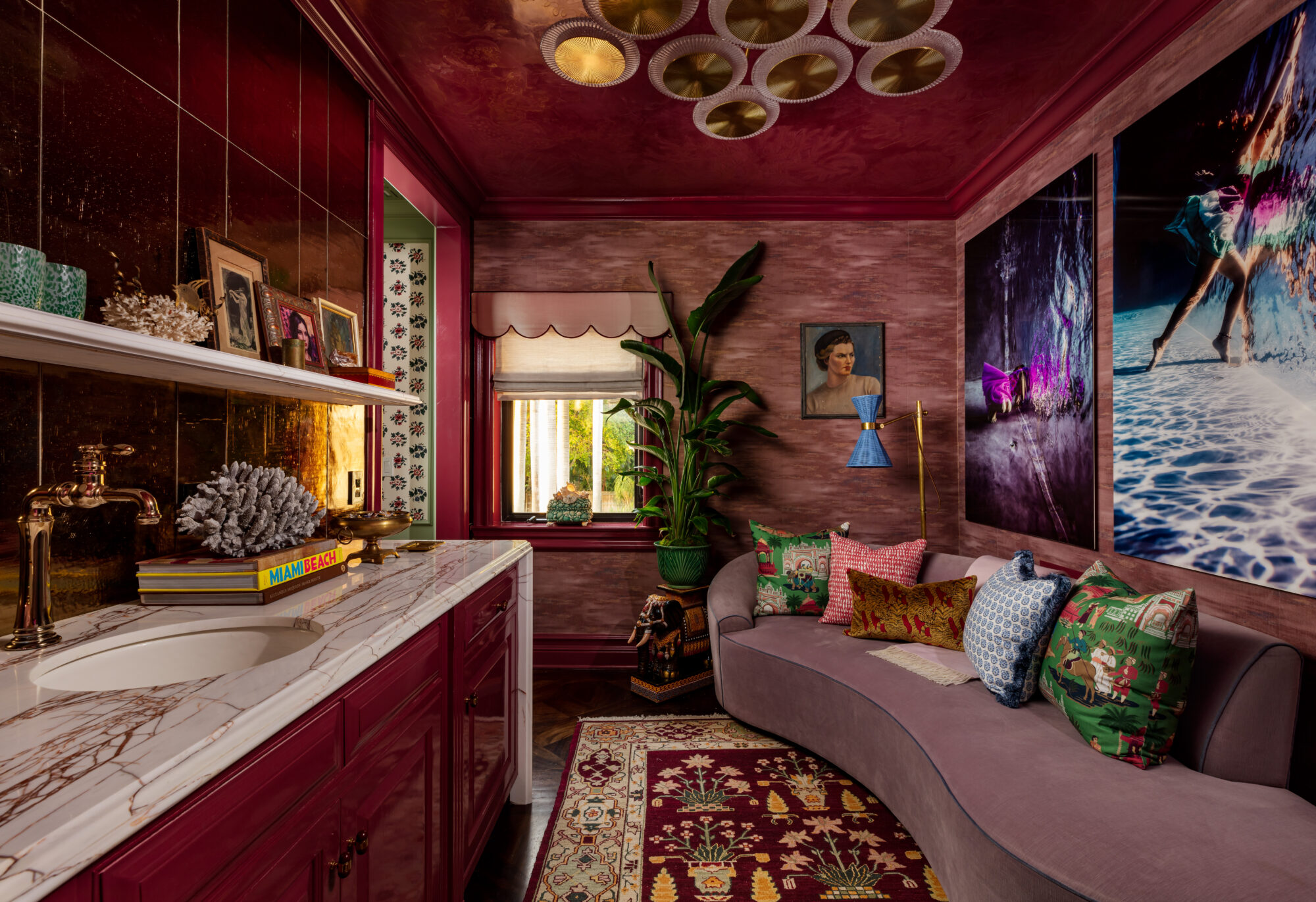 moody maximalist jewel-toned side bar with rosy velvet couch and lighting