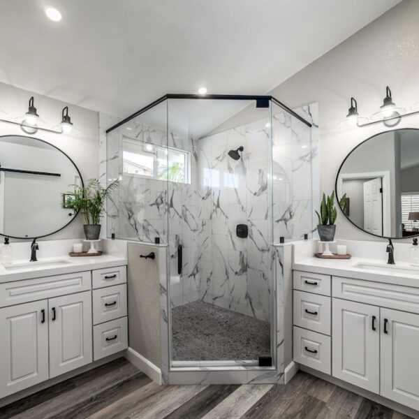 marble shower with white cabinets in Southern California home by Coastal Home Design Studio