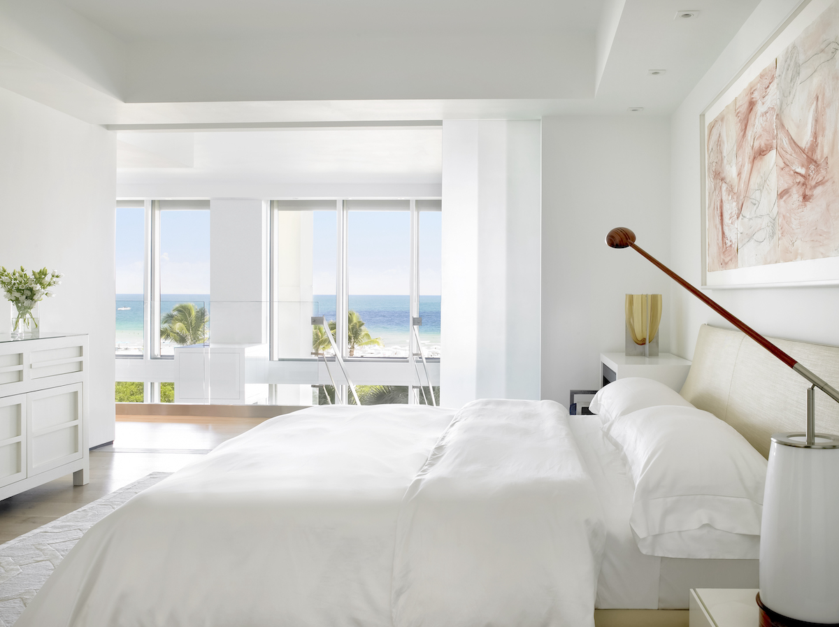 white bedroom, wall art, open windows, large shades