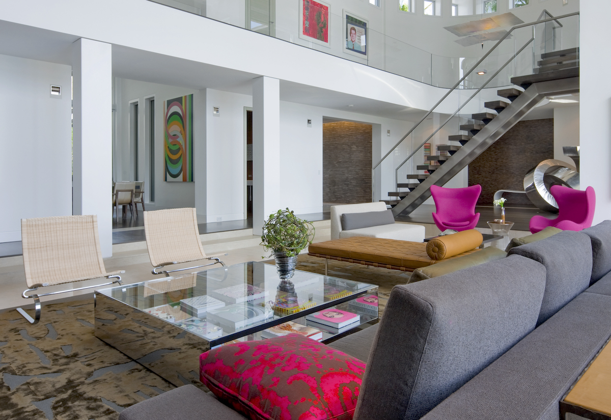 Grey couch, pink side chairs, two story, glass staircase