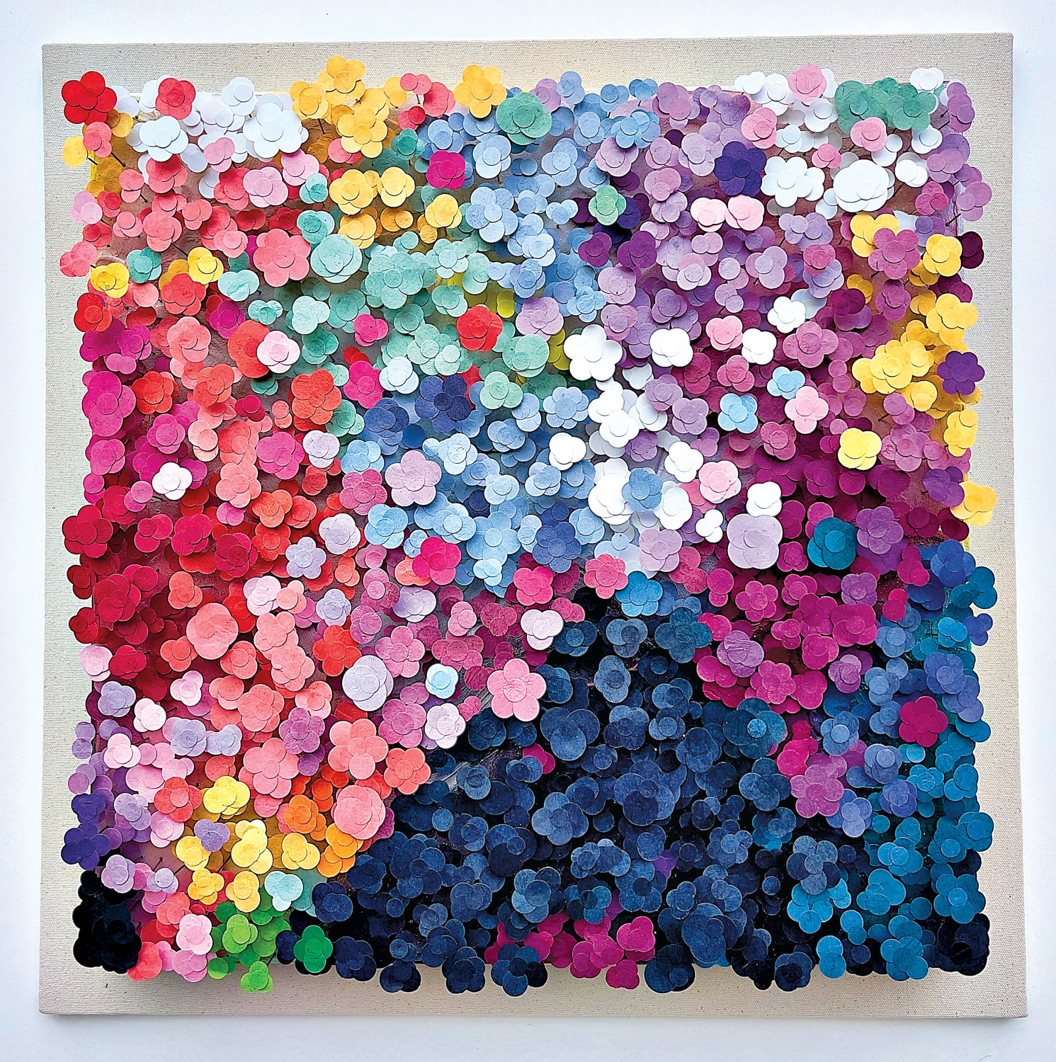 Large sculptural artwork of colorful layered hand-painted and hand-sculpted flowers