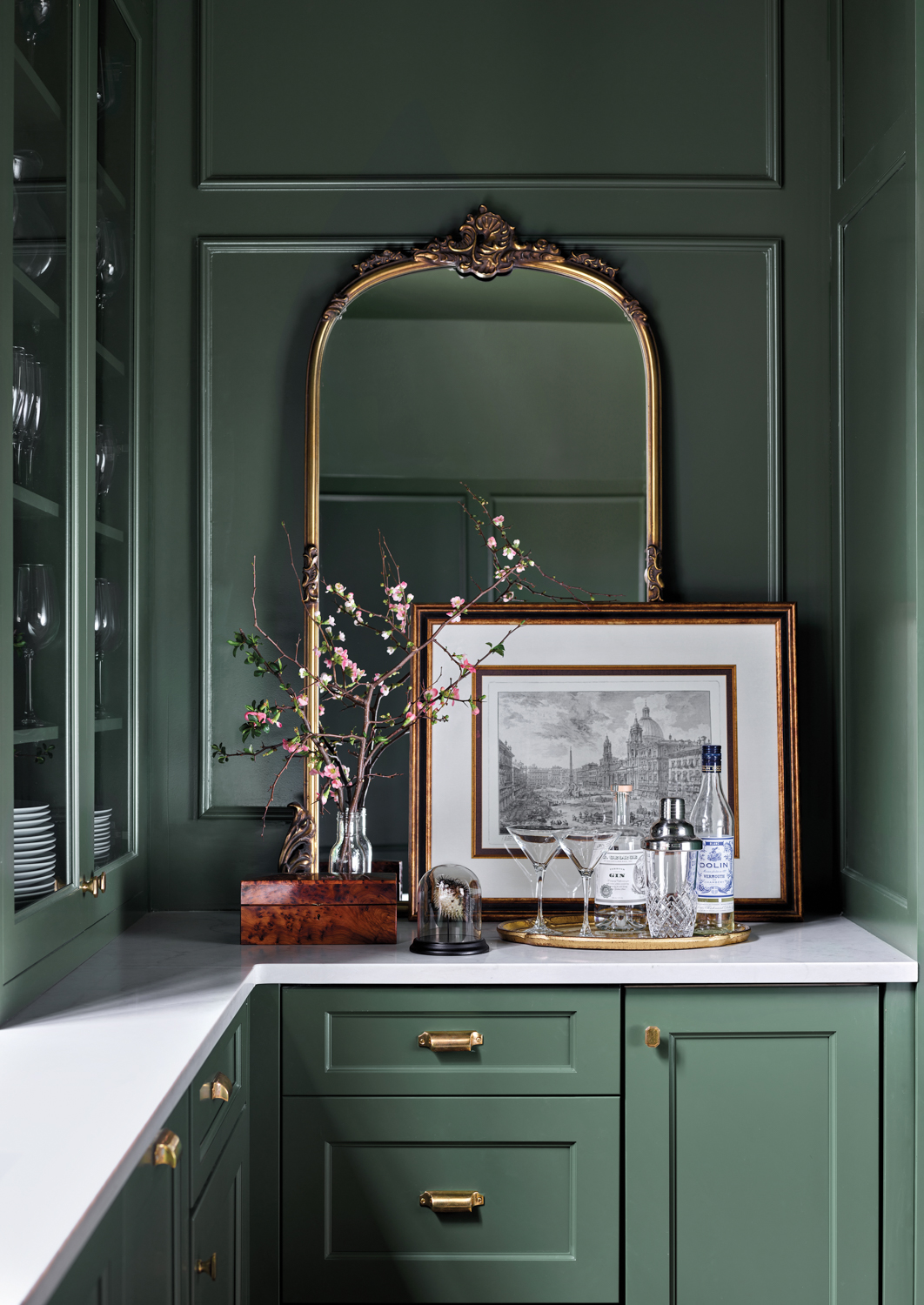 green kitchen with mirror and artwork