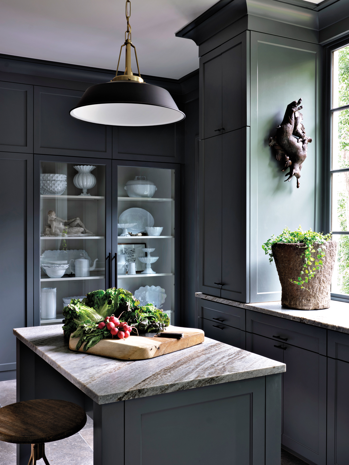 green grey kitchen with glass cabinetry