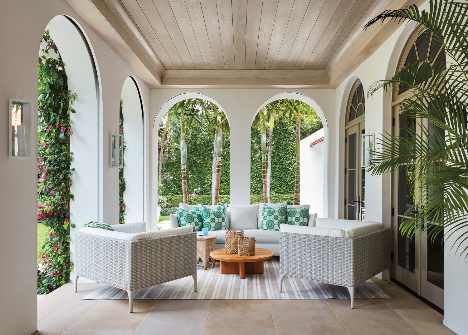 relaxing outdoor entertaining space in loggia with white armchairs and sofa
