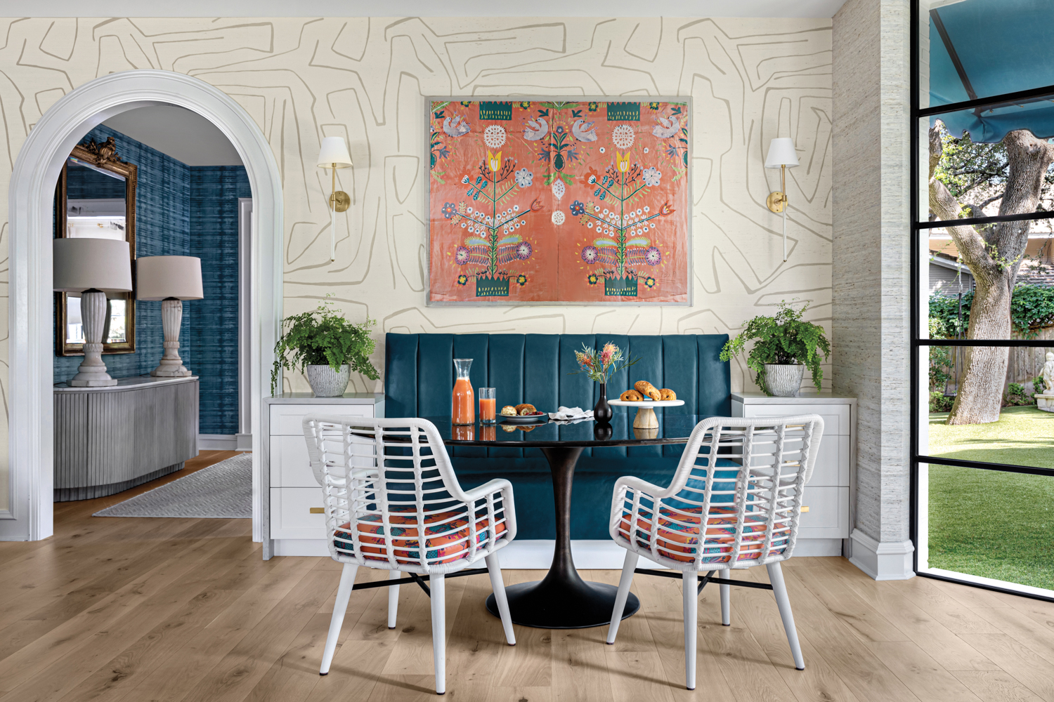 Geometric wallpaper and blue banquette in breakfast nook by Texas female design pro Anna Grasso-Gay