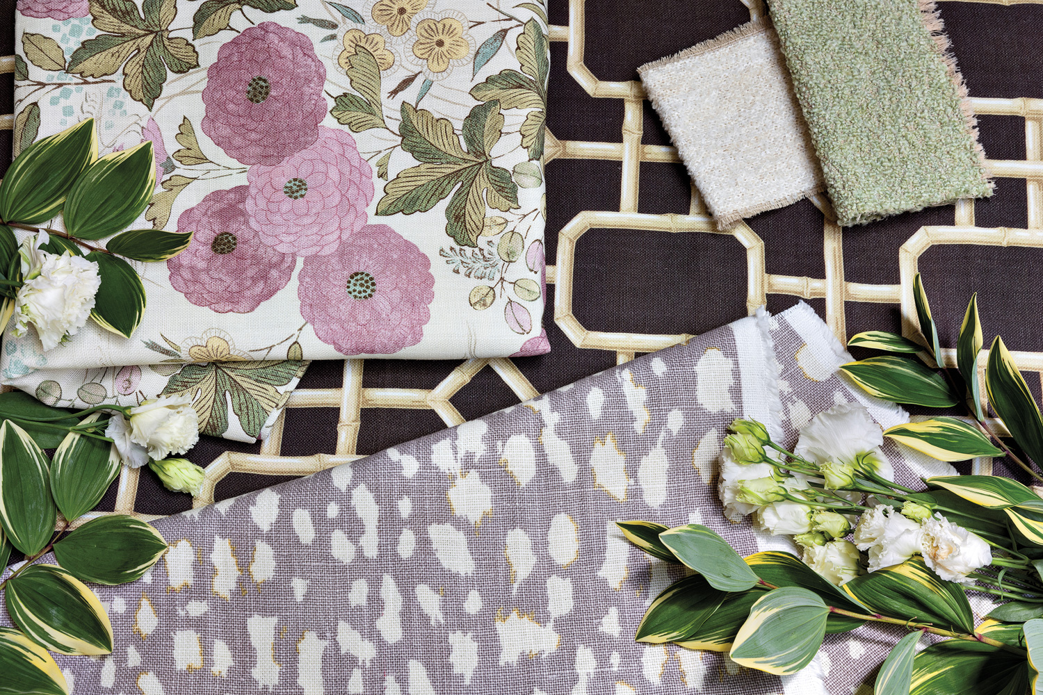 Jan Showers x Kravet's patterned and floral fabric samples with fresh flowers and greenery