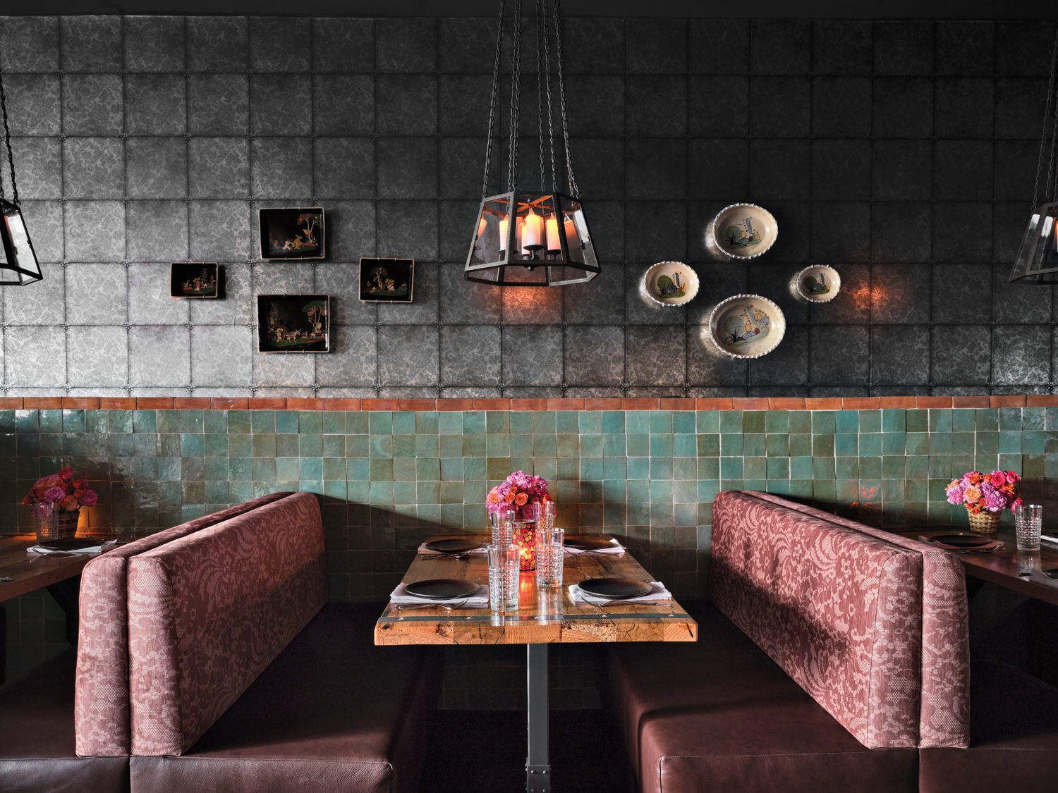 Pink booth seating alongside square floral gray tile and handcrafted teal tile in Texas restaurant