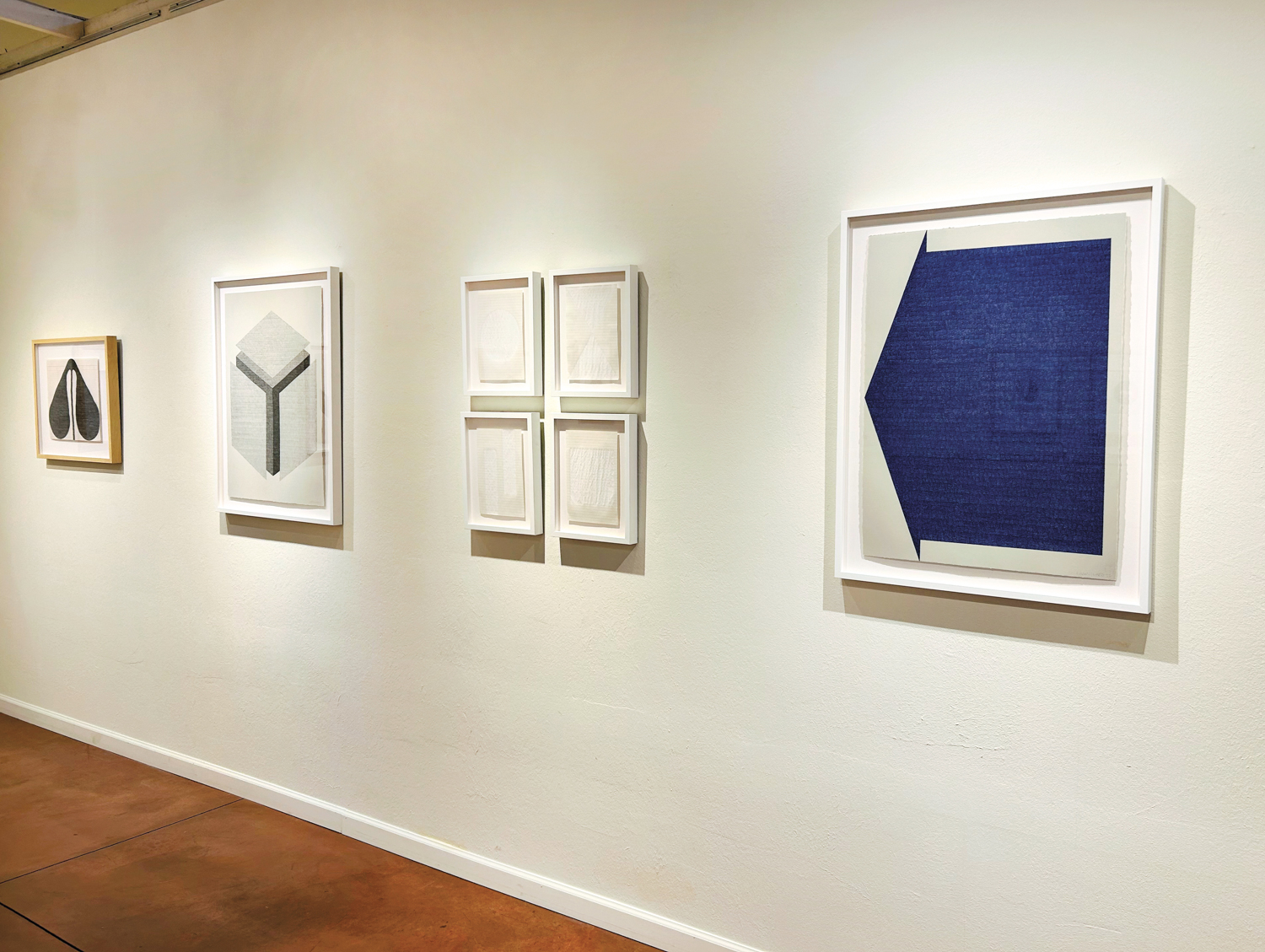 Minimalistic artworks on display on a gallery wall in Tucson