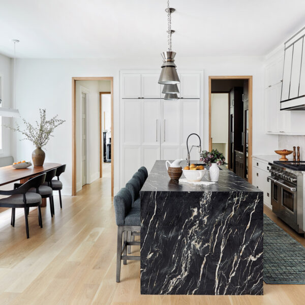 kitchen with black marble island and built-in banquette with long oval wood table