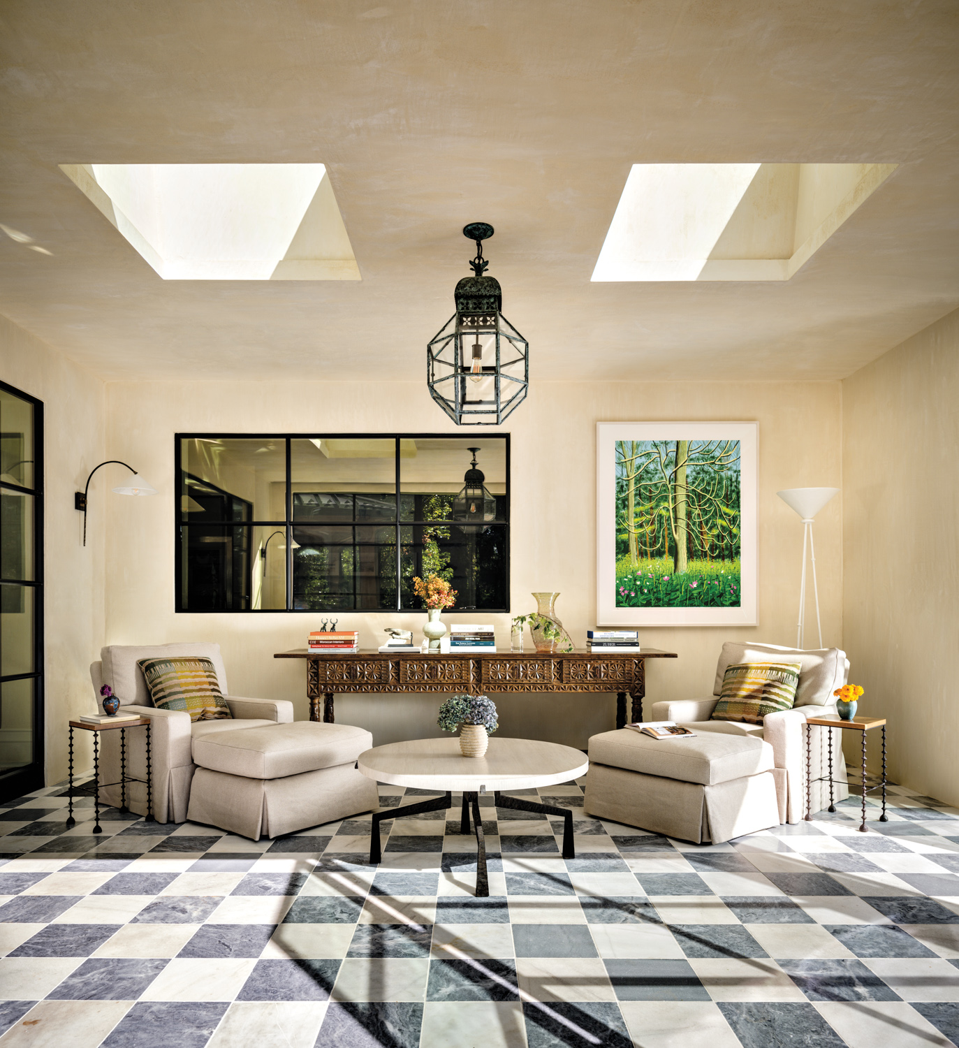 solarium with black-and-white checkered marble floors, an antique console table and coffee table