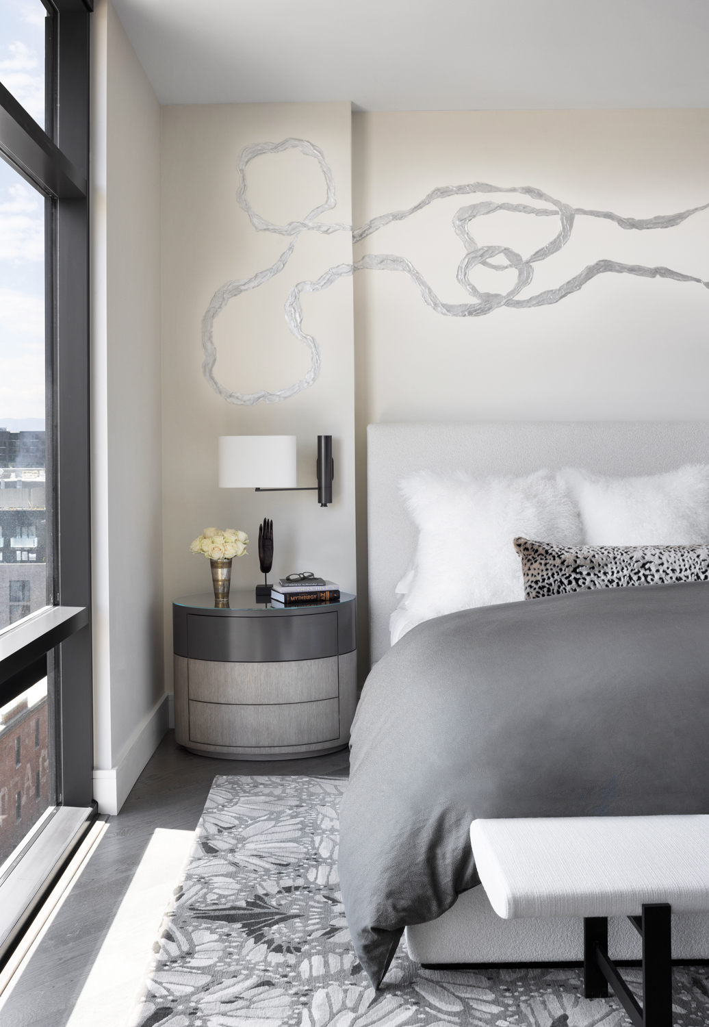 bedroom with gray bed, a...
