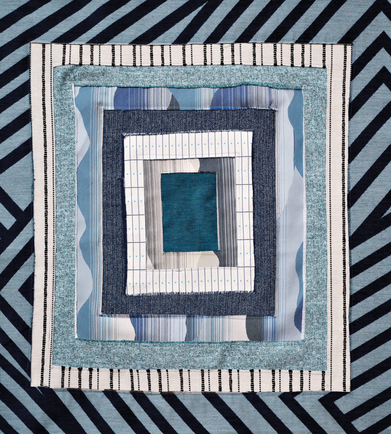 Part of Liz Collins x Pollack fabric collection, multiple blue squares all neatly stacked together