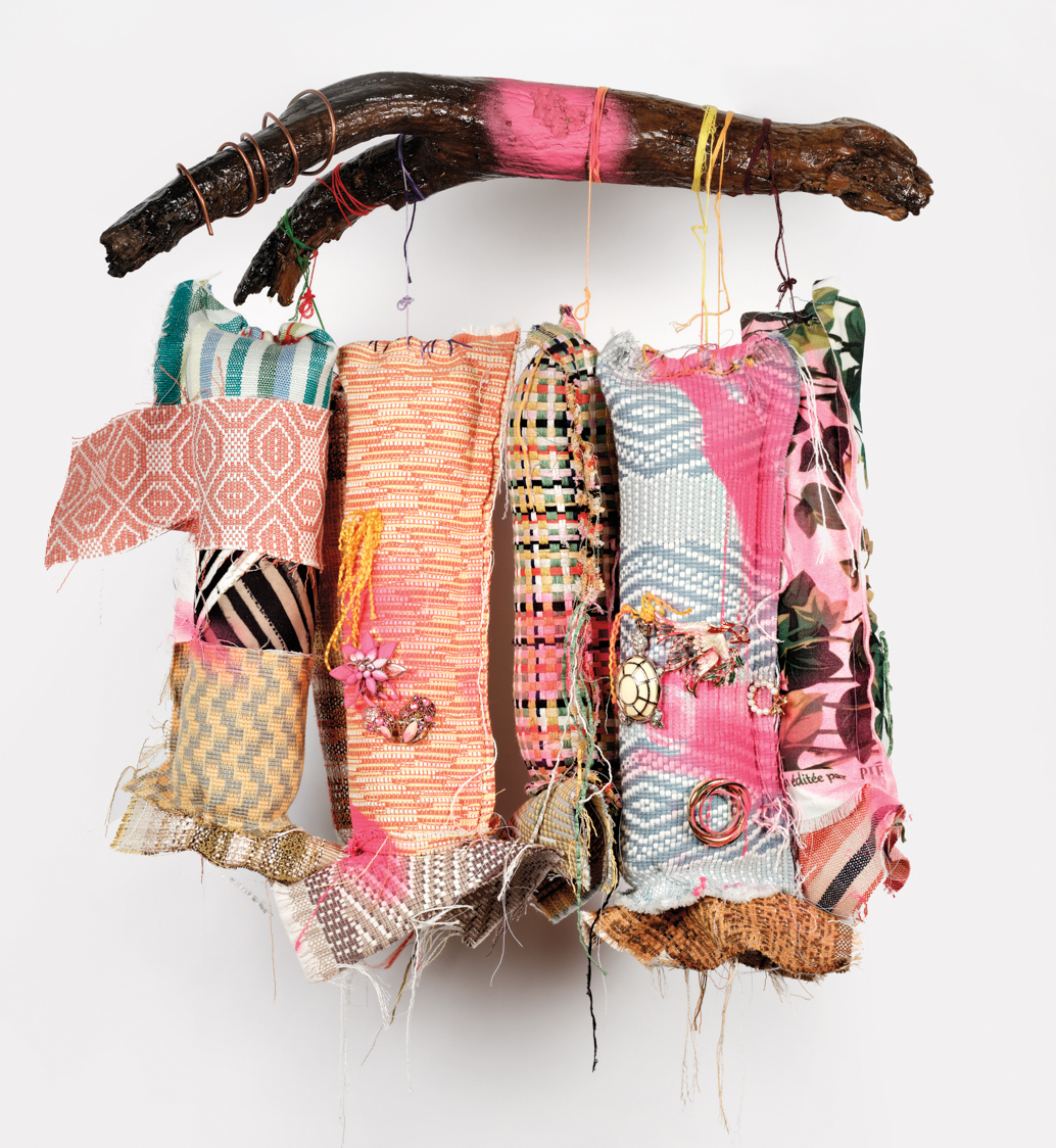 Part of September Grey x Pierre Frey fabric collection, four cloth hanging on wooden branch