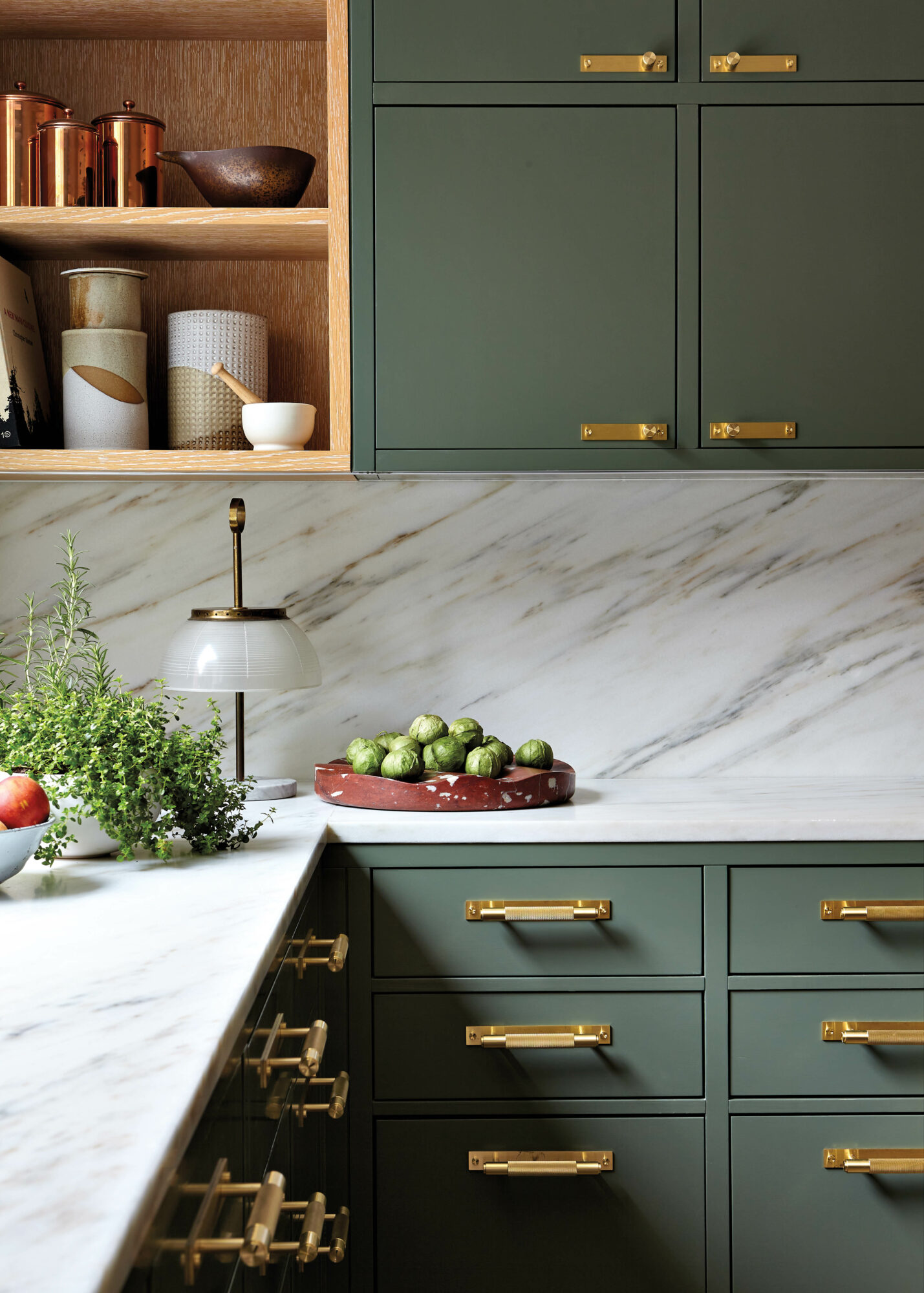 kitchen with green cabinetry, gold...