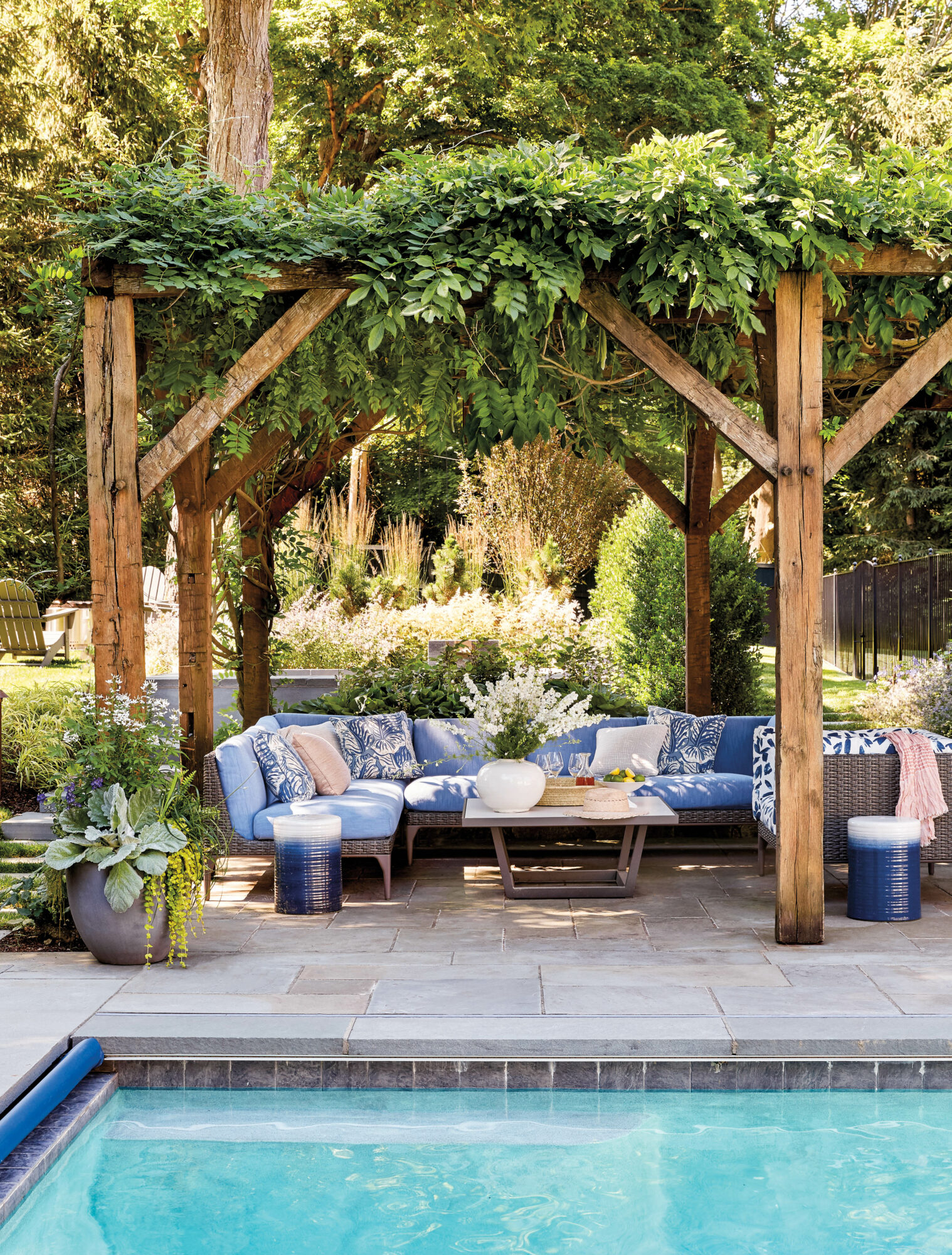 blue outdoor sectional under pergola...