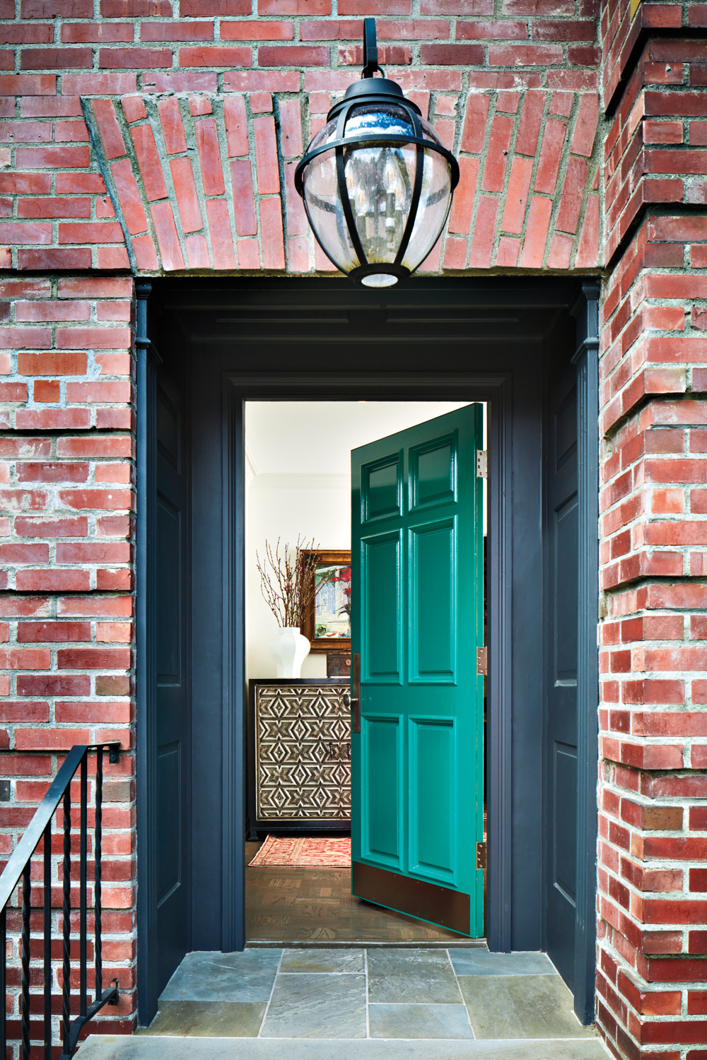 Green door on brick house...