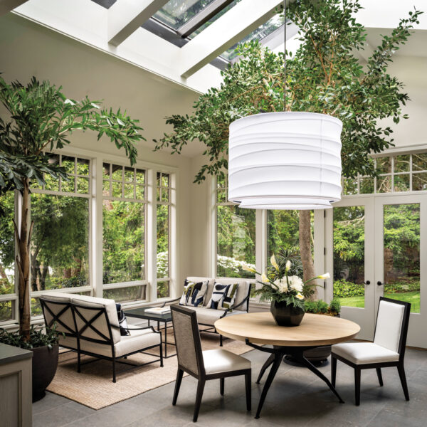 A sunroom has a large light fixture and is inspired by the Whidbey Island landscape.