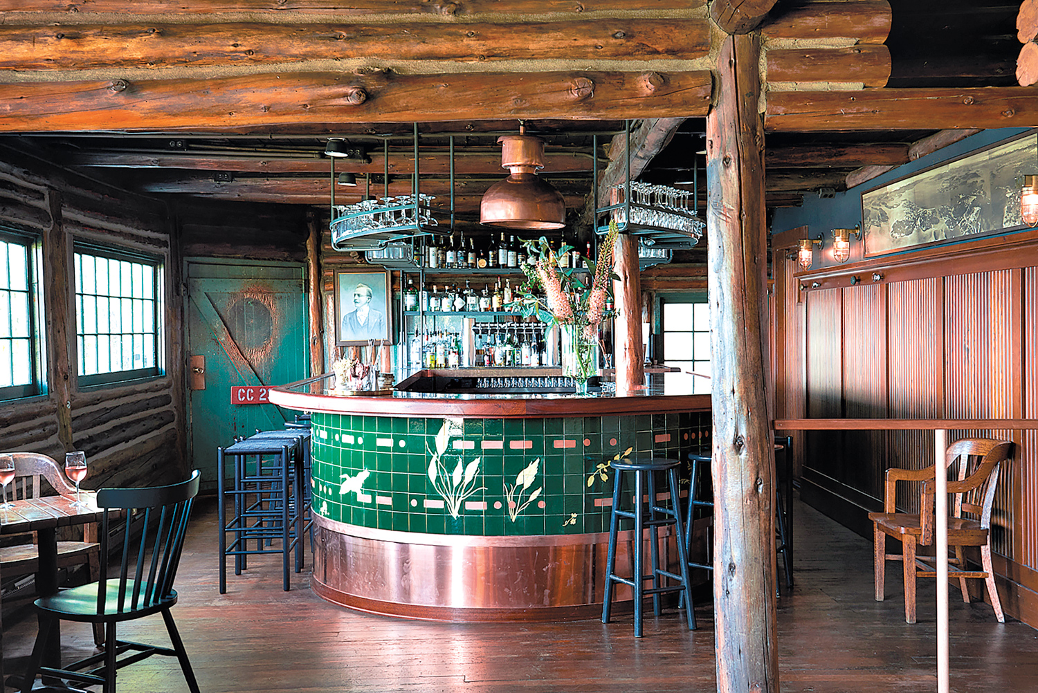 green-tiled bar with stools in wood-lined, cozy bar as part of a Whidbey Island design destination
