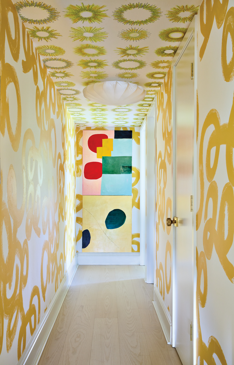 vibrant hallway with yellow wallpaper...