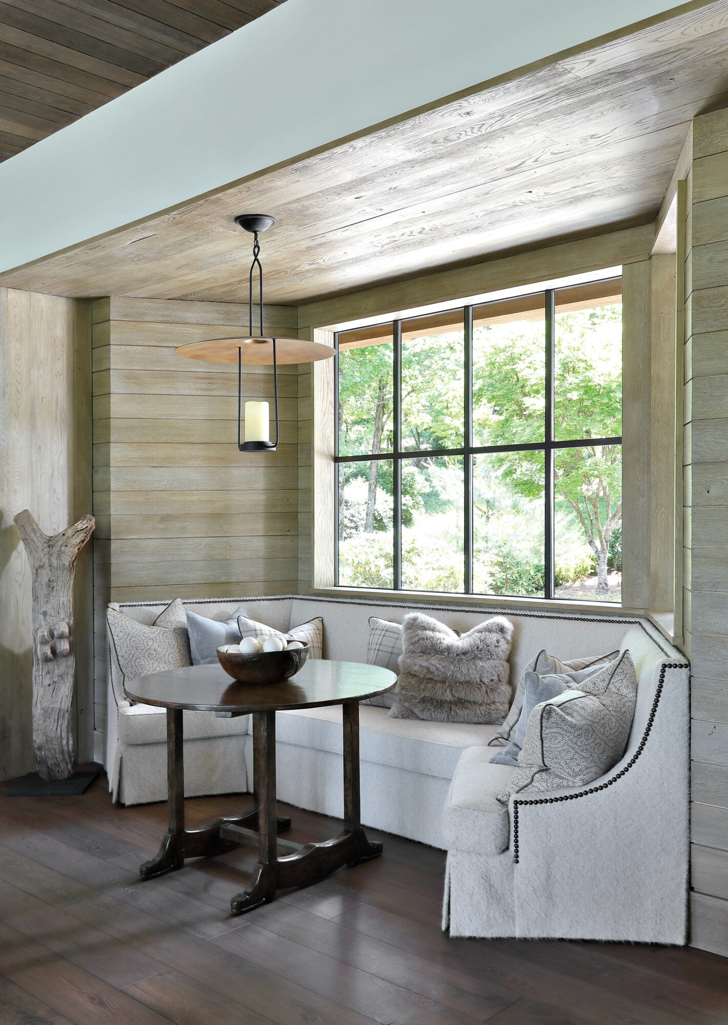 Wood-paneled dining nook with banquette...