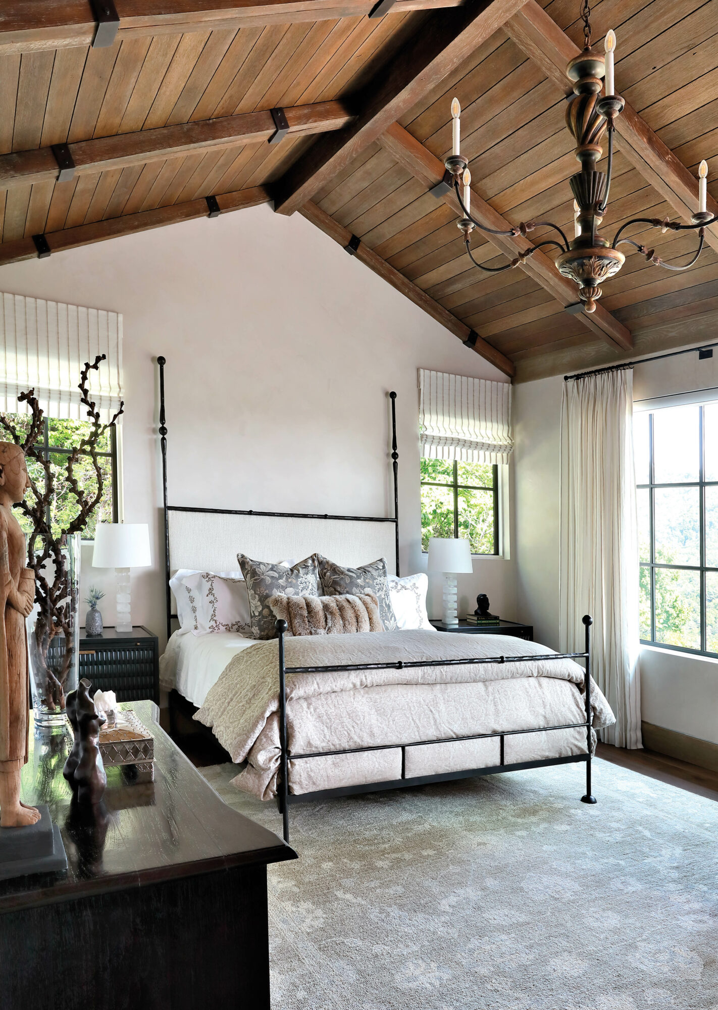 Off-white bedroom with vaulted ceiling,...