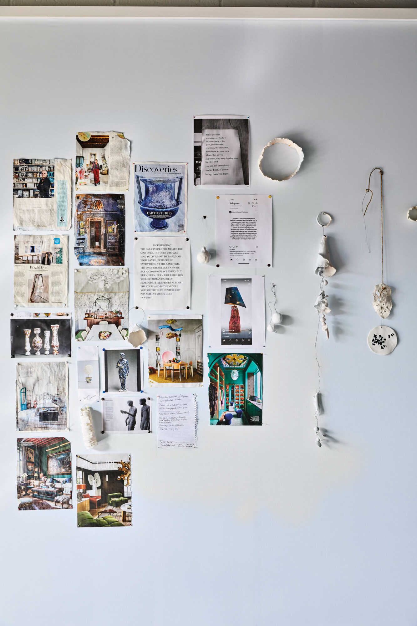 Dana Castle's studio wall tacked with inspirational pictures, words and objects
