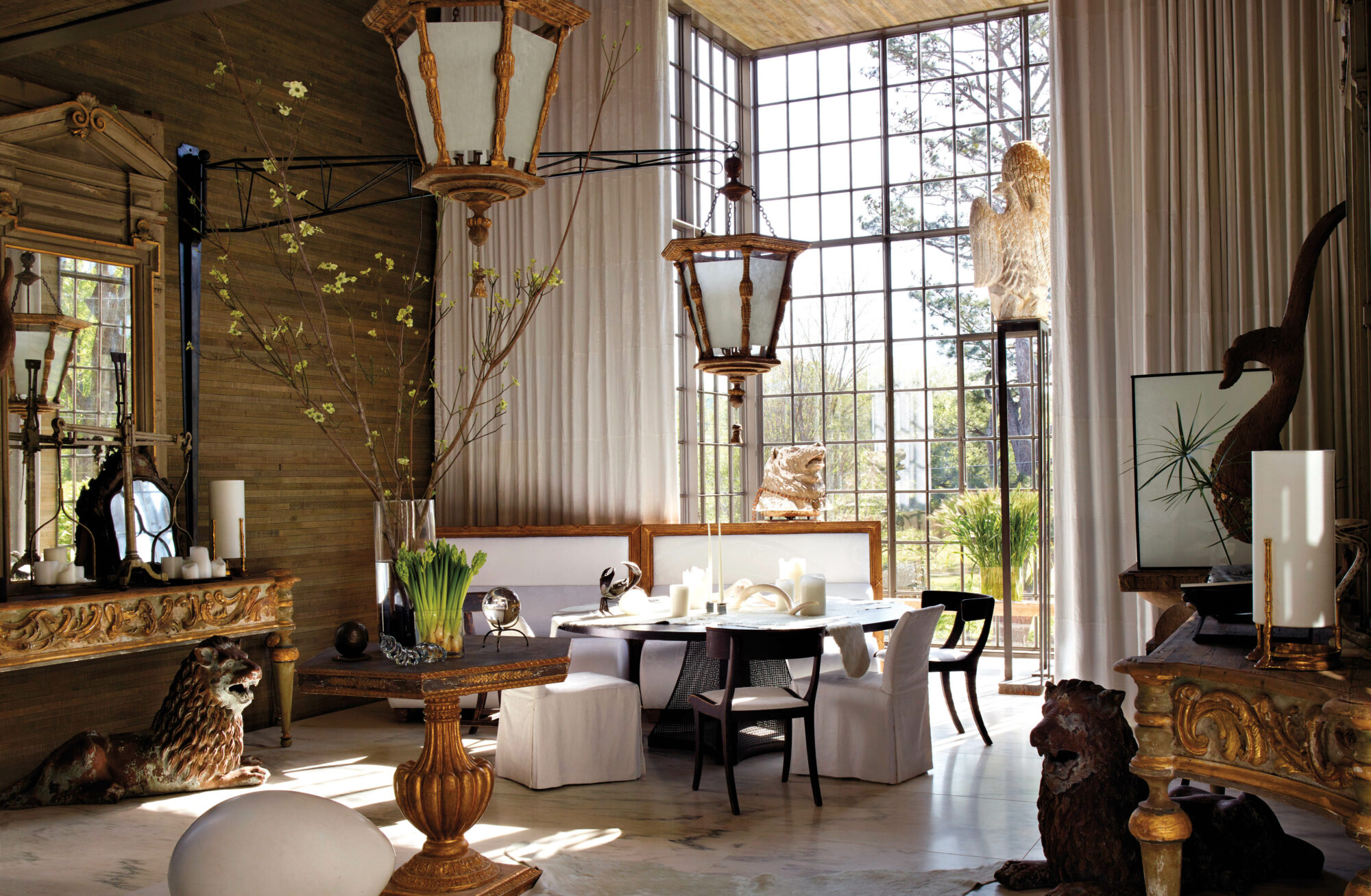 Southeast design book featuring dining area with ornate floor-to-ceiling windows and lion sculptures underneath