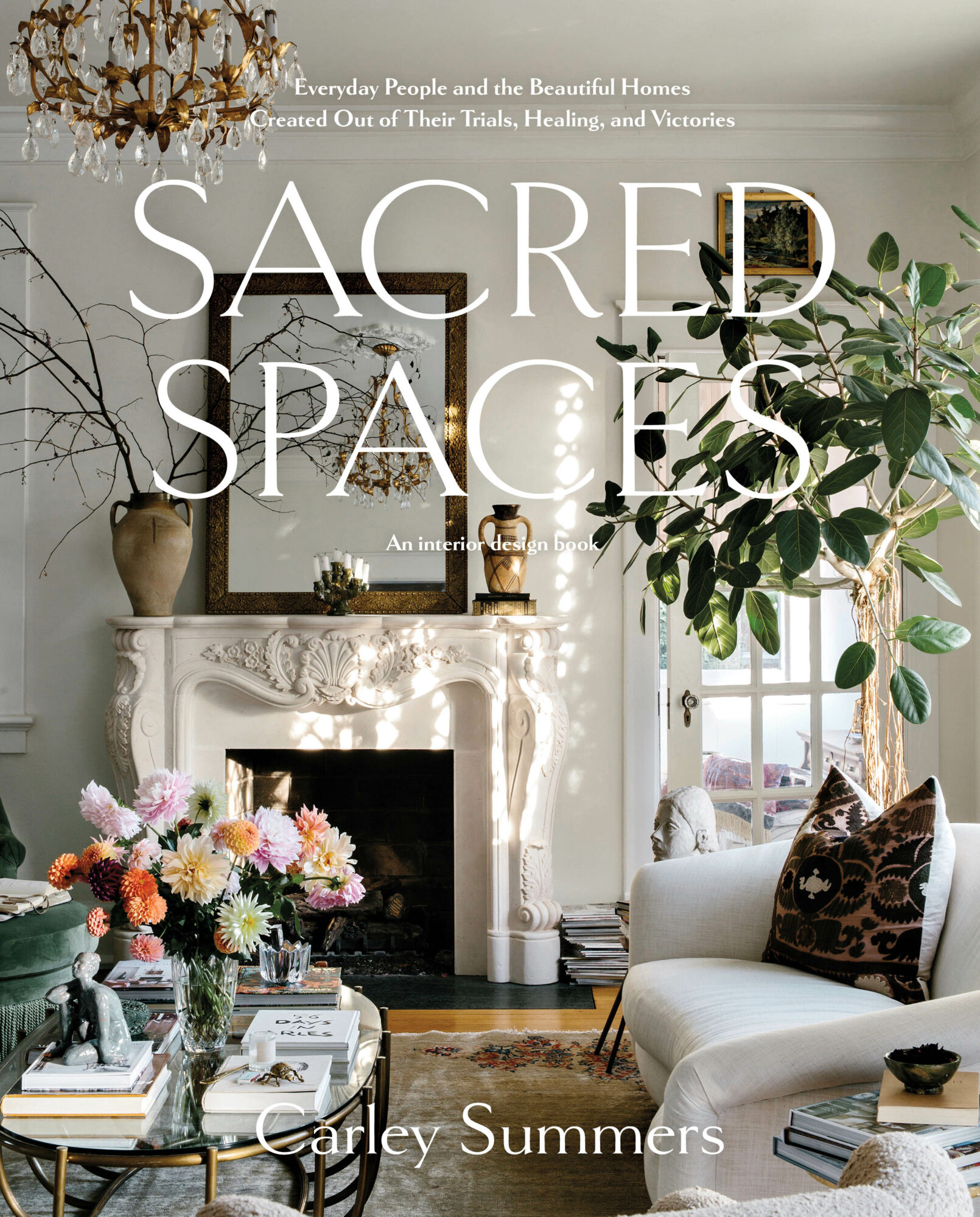 Sacred Spaces design book cover featuring a living room with a white fireplace, sofa and coffee table