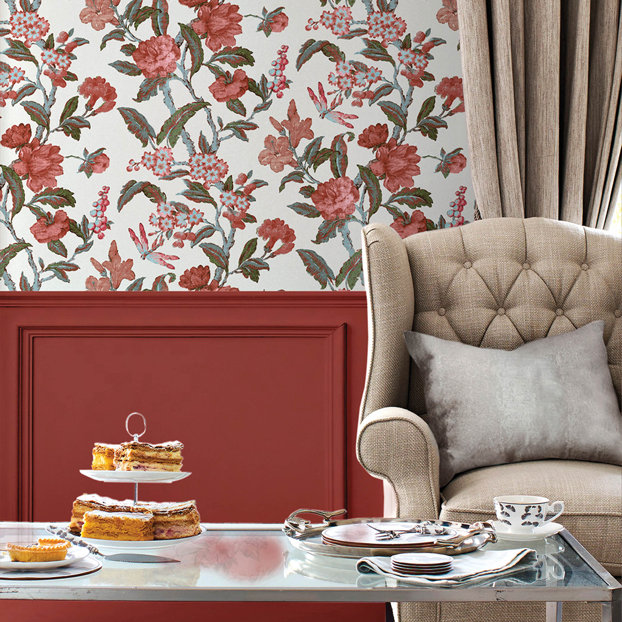 Pink-floral Laura Ashley wallpaper behind a cream wing-backed armchair in front of a coffee table