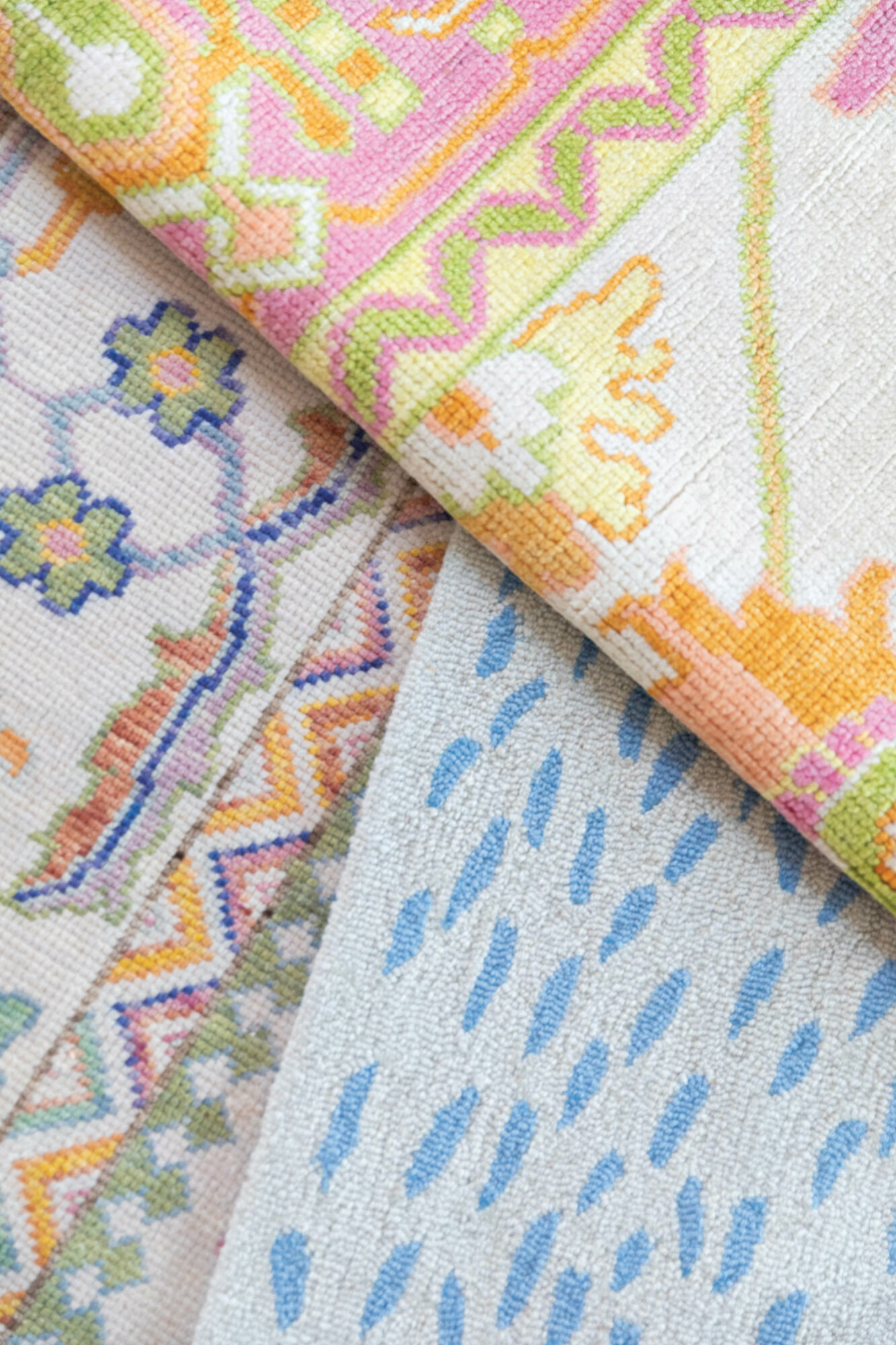 Close-up of overlapping colorfully patterned rugs from English Village Lane