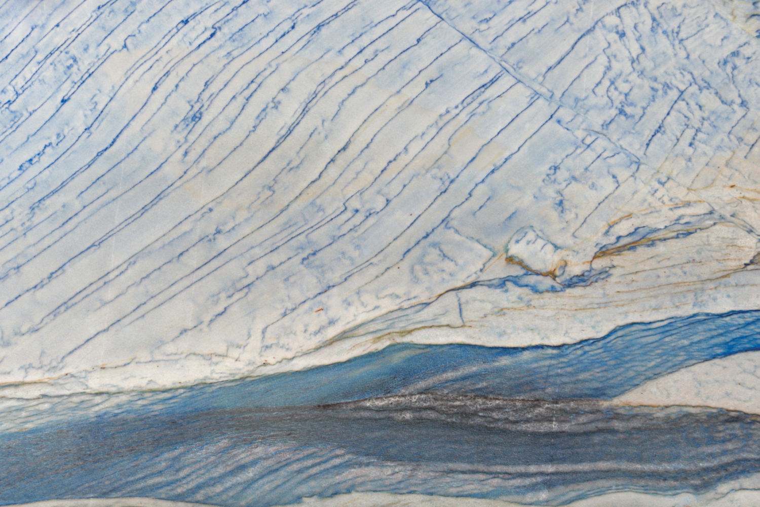 Blue and white quartzite slab with ripples of dark blue throughout recommended by Sherrell Neal