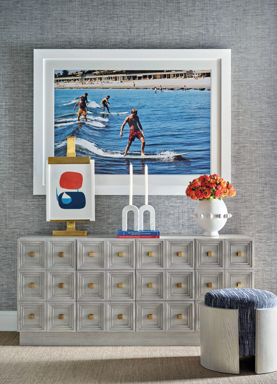 Gray console sits beneath photograph of surfers, part of Benjamin Johnston x Chaddock collection