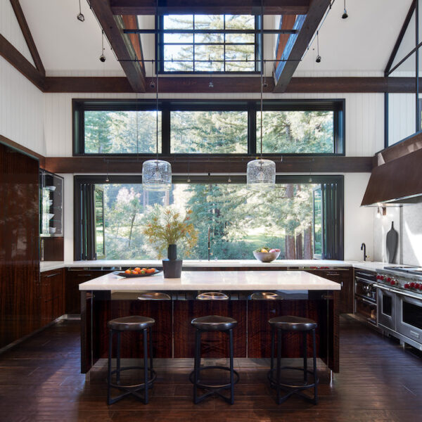 Contemporary kitchen and dining room with wood beams on ceiling and hard wood floors in Northern California home by De Mattei Construction