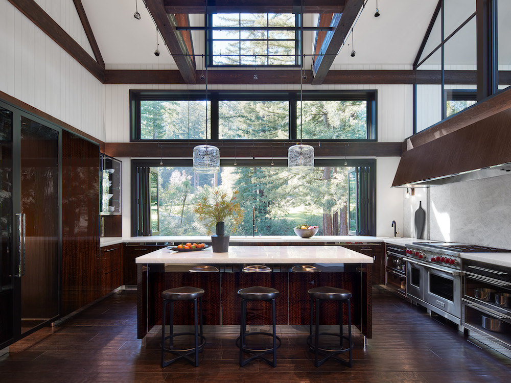 Contemporary kitchen and dining room with wood beams on ceiling and hard wood floors in Northern California home by De Mattei Construction