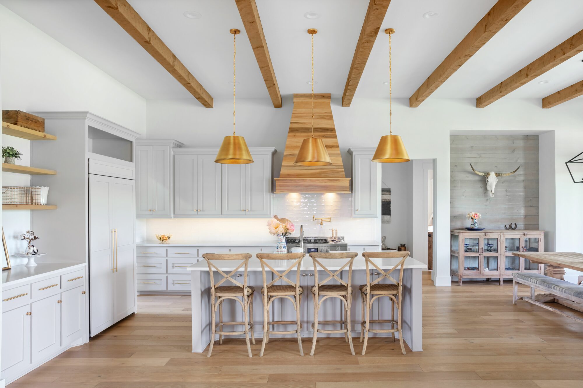 White, gold and wood highlight the kitchen