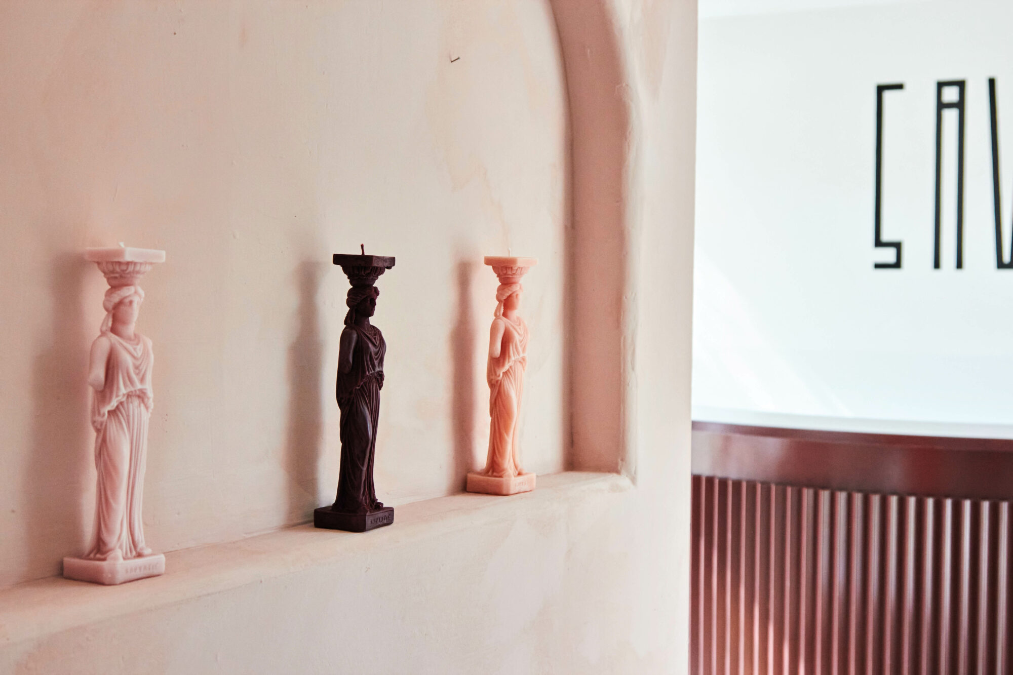 Black and pink candles from Savior made to look like Greek statues