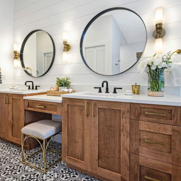 RED MAPLE LEAF MASTER BATH, black frame circular mirrors, wood cabinets, white countertops